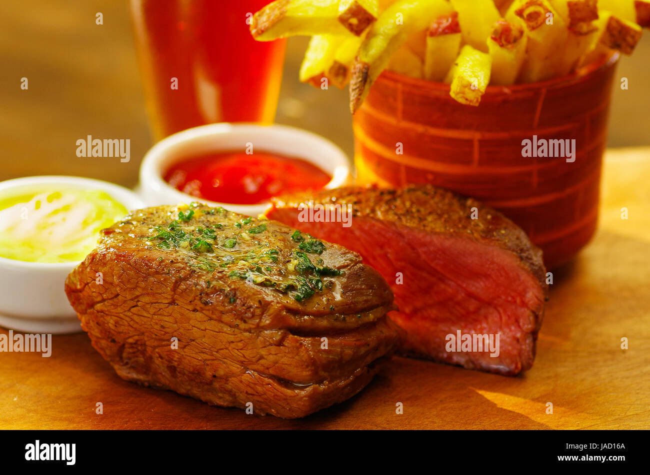 Welldone grilled marinated beef flank steak with ketchup, mustard