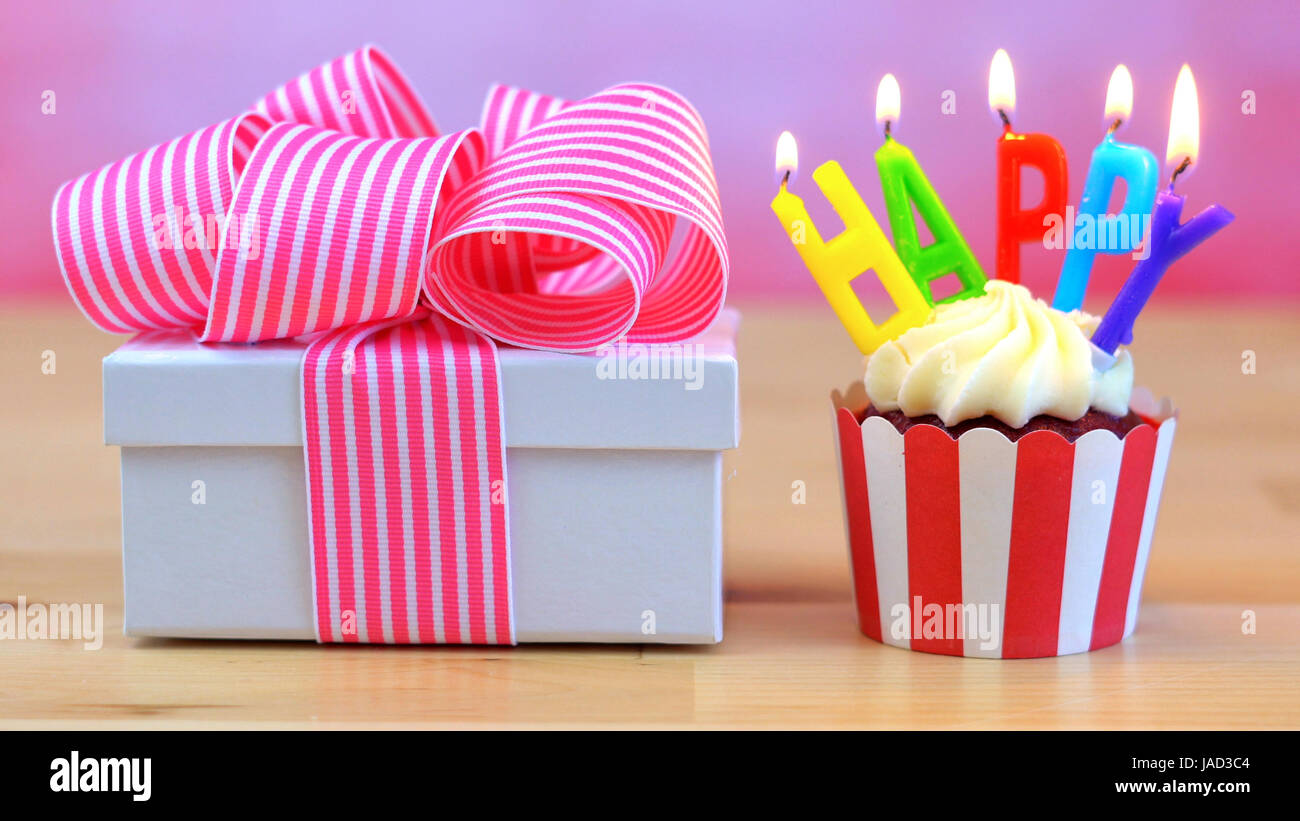 Happy Birthday Cupcake With Colorful Candles With Small Gift Wrapped In Pink Ribbon Candles Burning Stock Photo Alamy