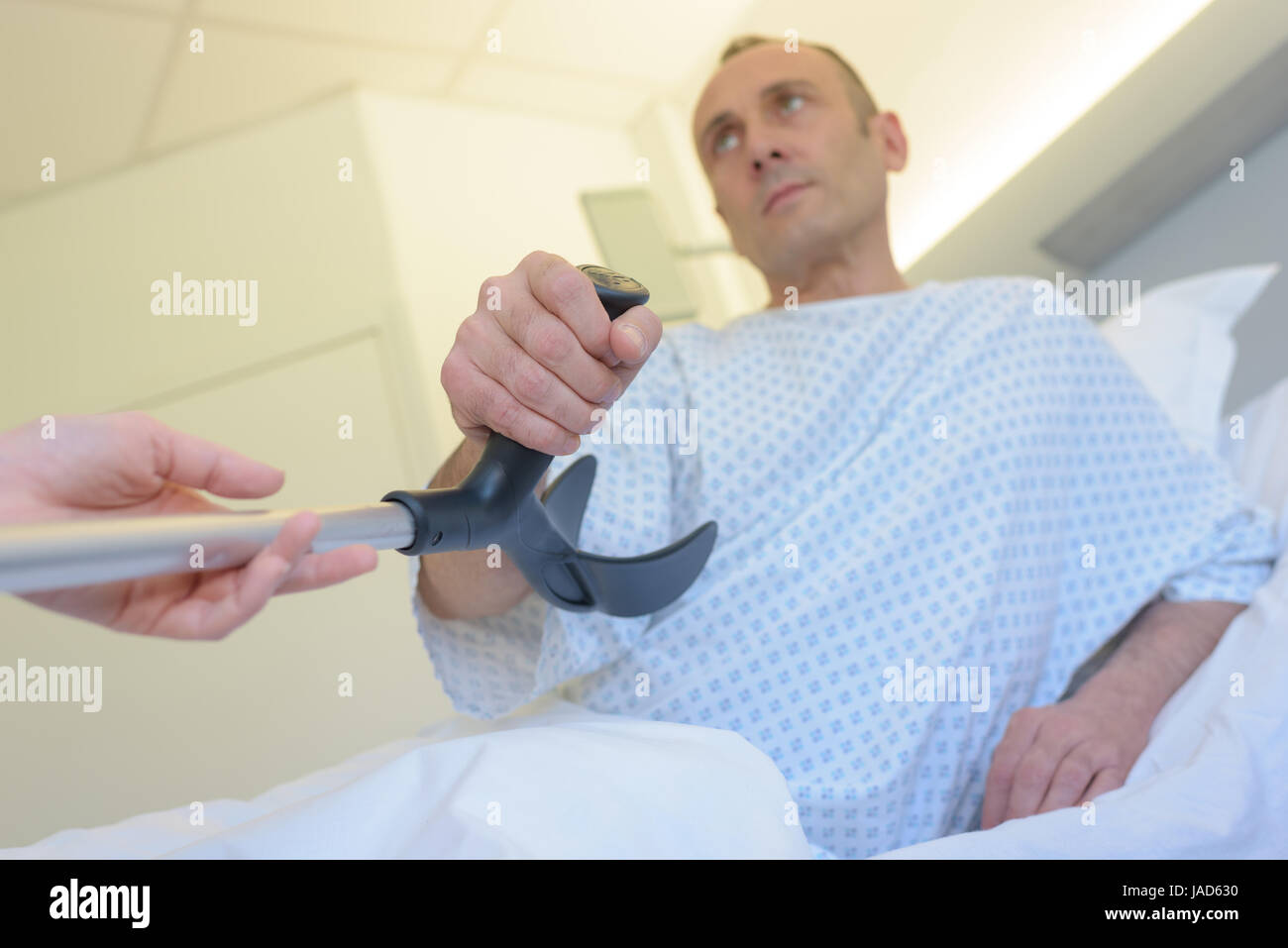 male patient gets crutches from doctor Stock Photo