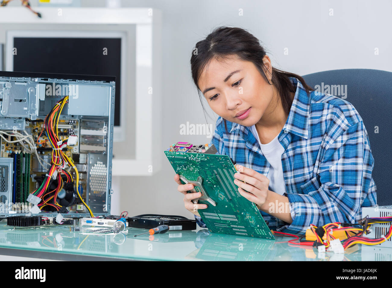 young woman fixing a computer motherboard Stock Photo Alamy