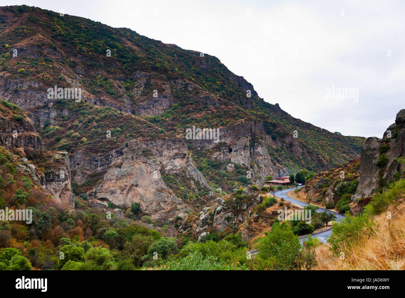 Cliffs and the road in gorge of Azat river in Armenia. Cliffs surrounding Geghard monastery and Azat river gorge are included together with the monastery in the World Heritage Site listing. Stock Photo