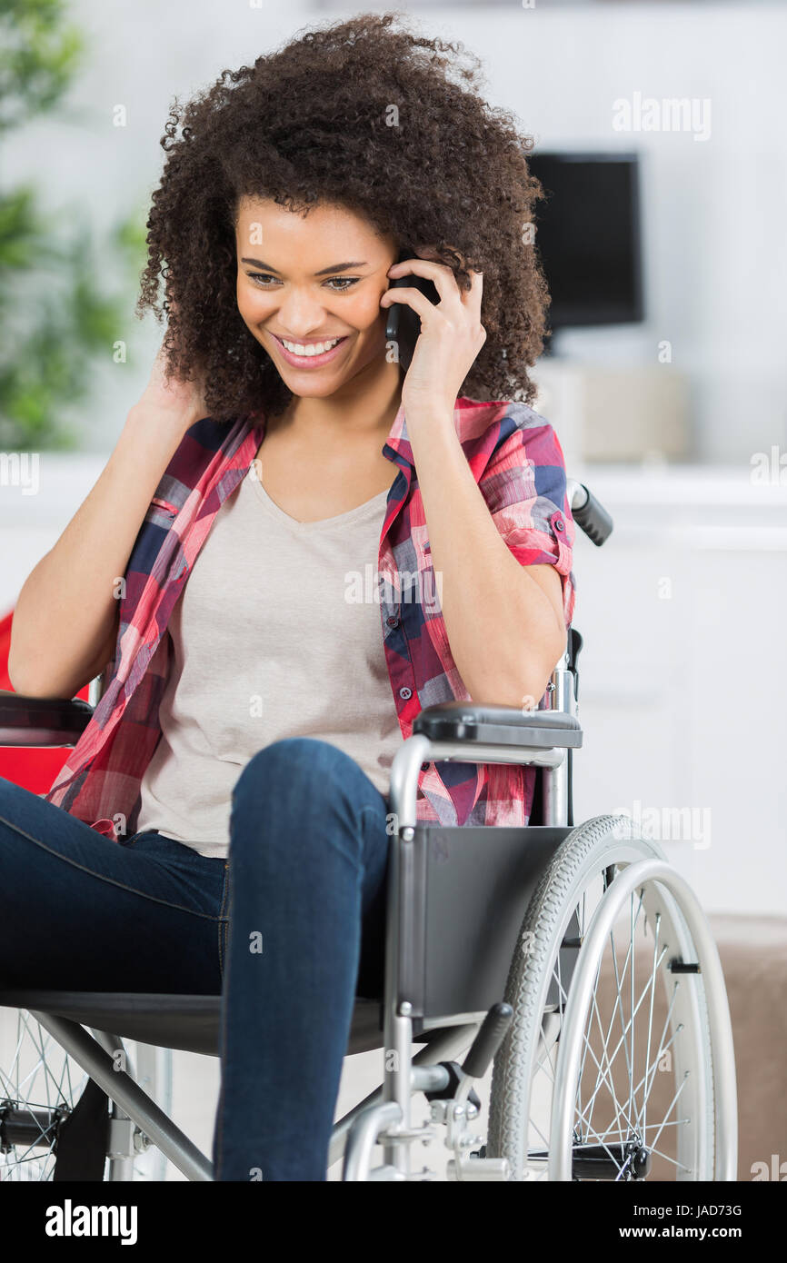 disabled woman in wheelchair on mobile phone Stock Photo Alamy