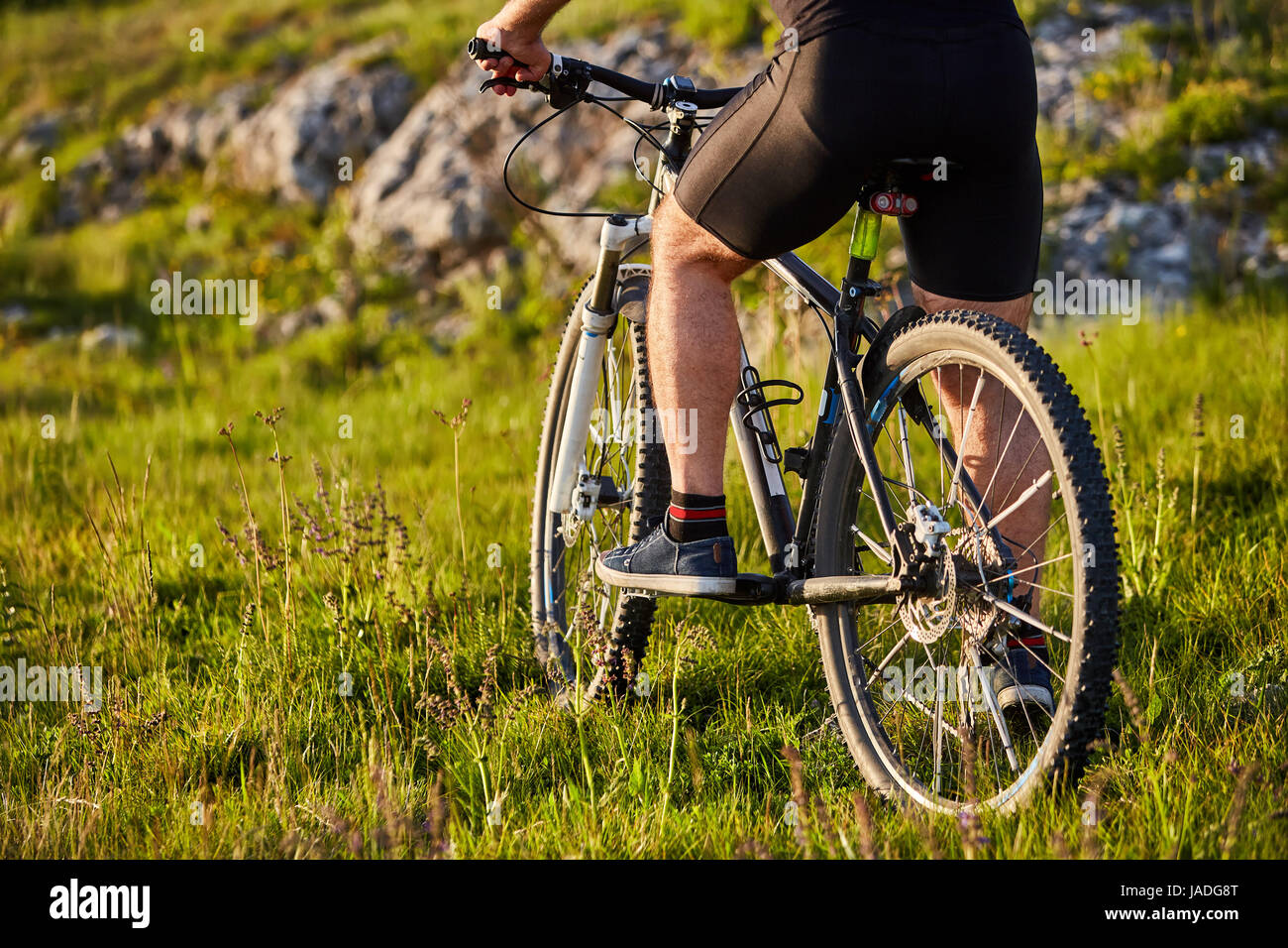 Foot Riding Away Close-up of detail of cyclist man feet riding mountain bike on rocky ...