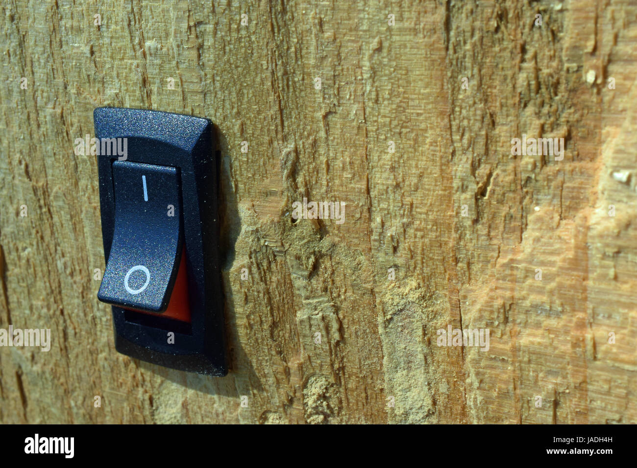 Power switch inserted on wood. Conservation, green business and alternative energy concept. Stock Photo