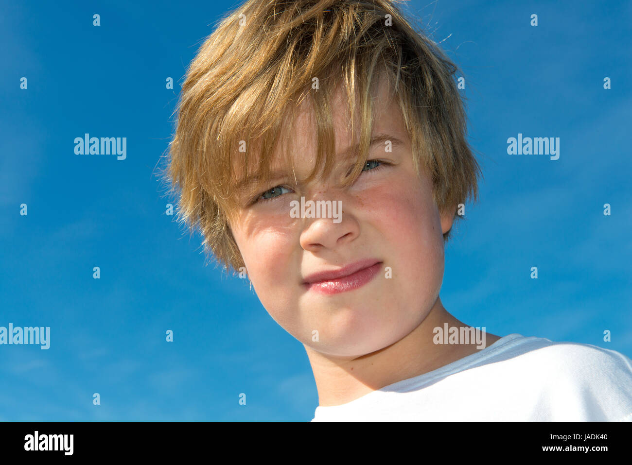 boy in front of blue sky Stock Photo - Alamy