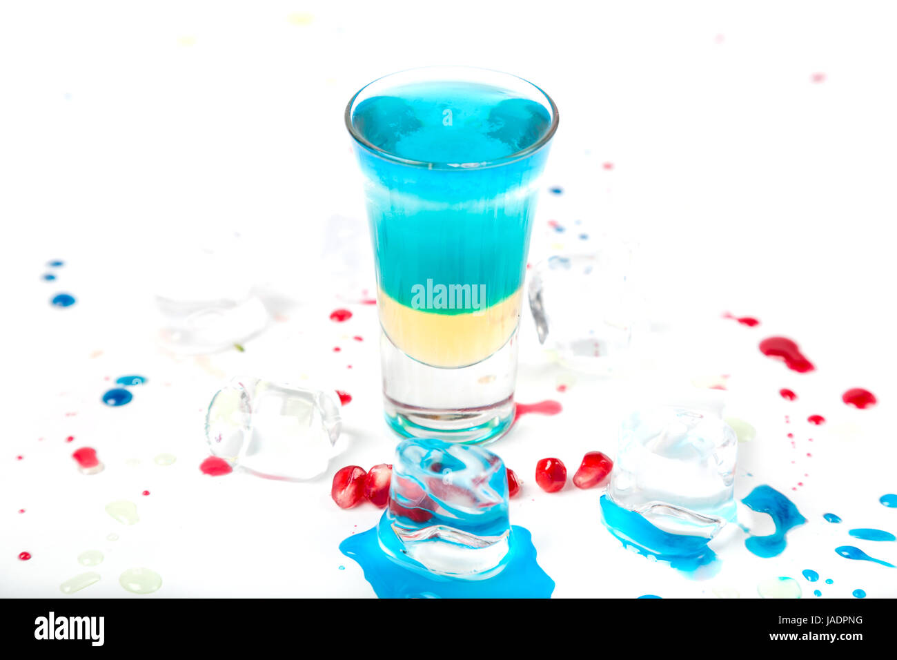 short blue coctail with ice and color drops on white Stock Photo