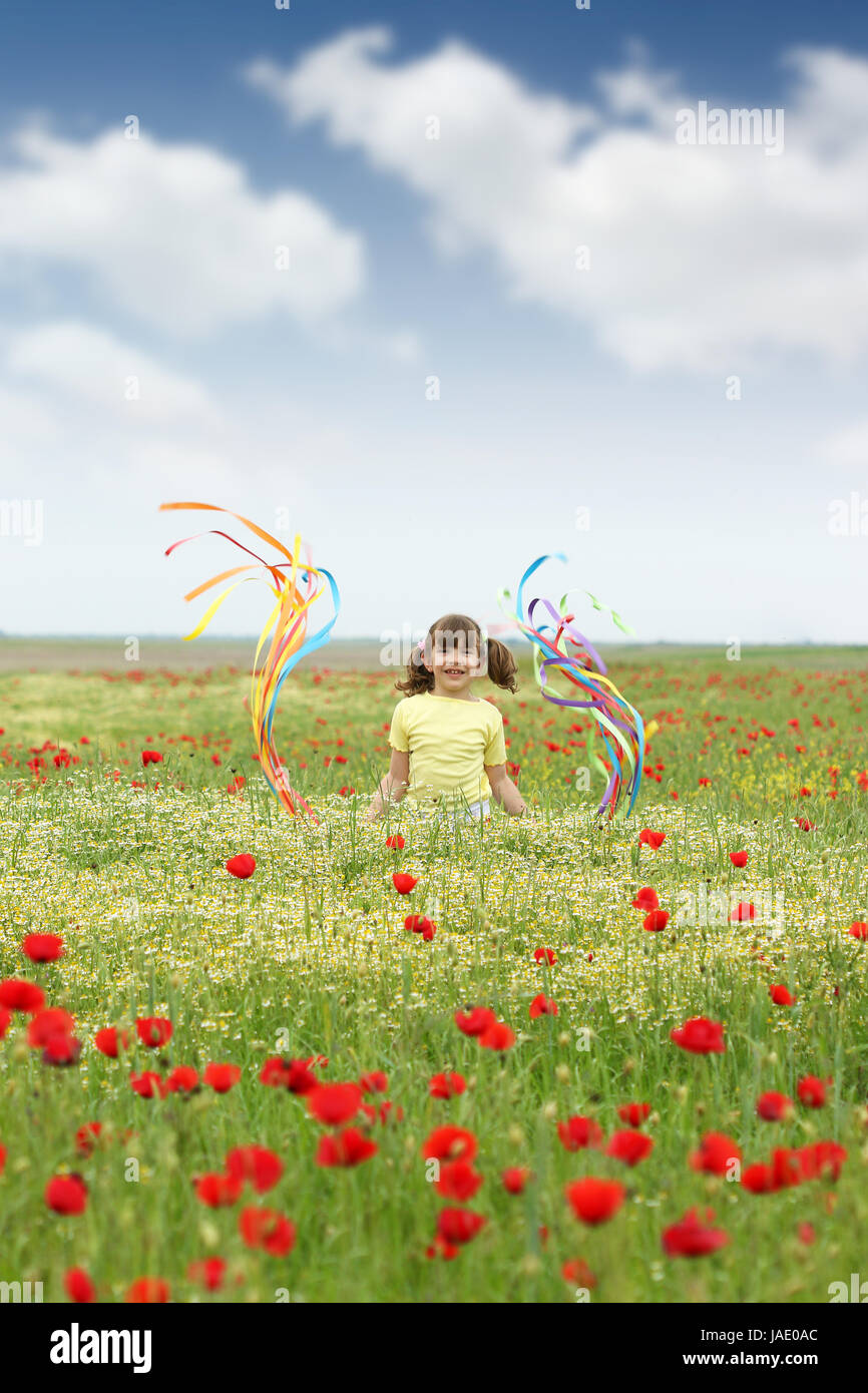 happy little girl on wildflowers meadow Stock Photo - Alamy