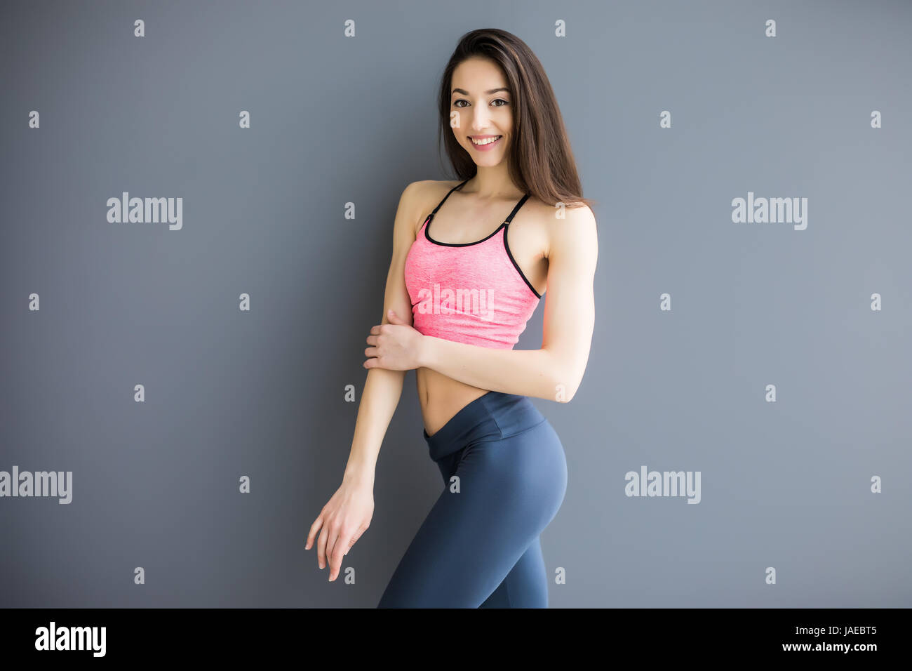 Sport girl isolated on gray background. Running fitness sport woman smiling  Stock Photo - Alamy