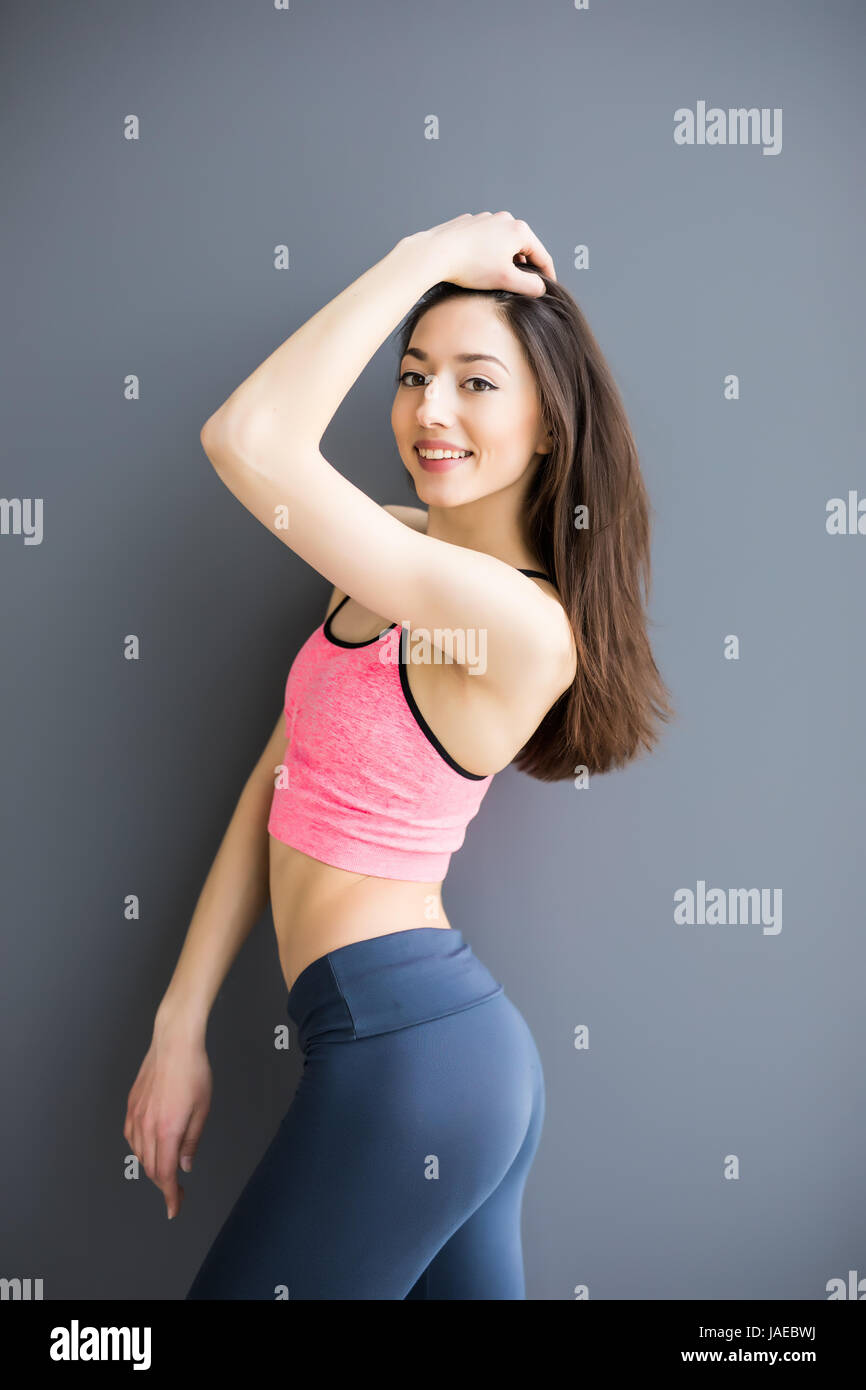 Sport girl isolated on gray background. Running fitness sport woman smiling  Stock Photo - Alamy