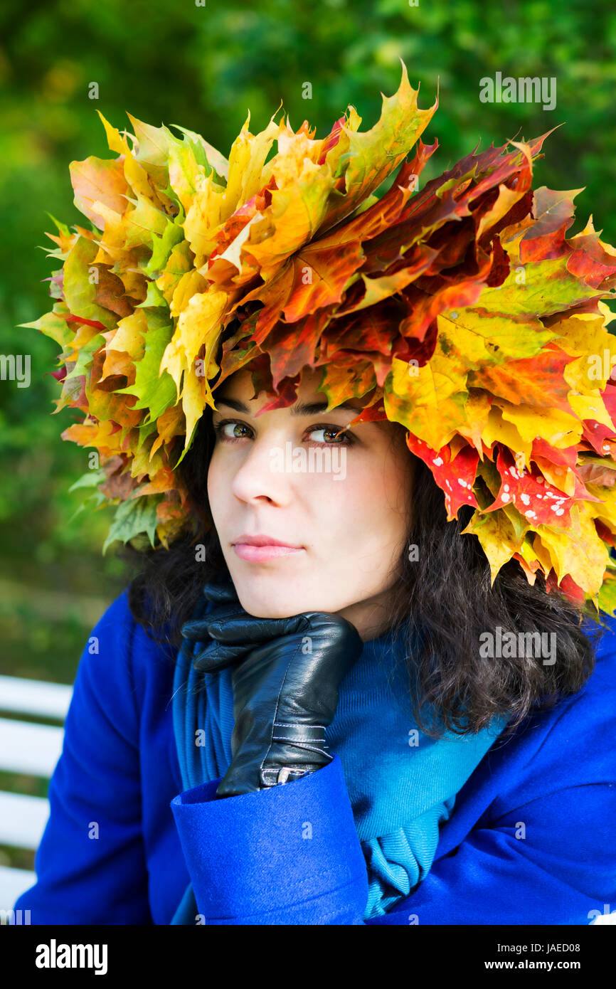 Thoughtful young woman with maple leaves on head Stock Photo - Alamy