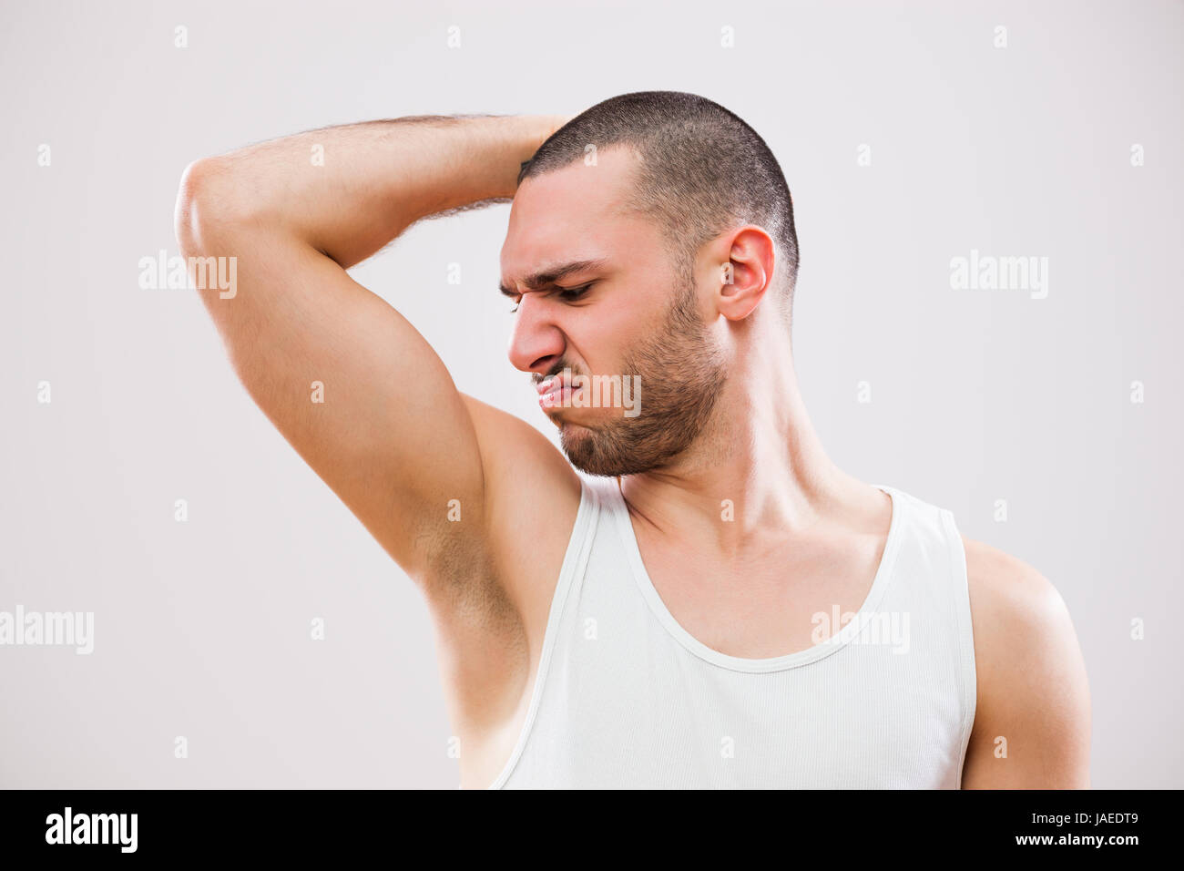 Young man is smelling his armpit before shower Stock Photo Alamy