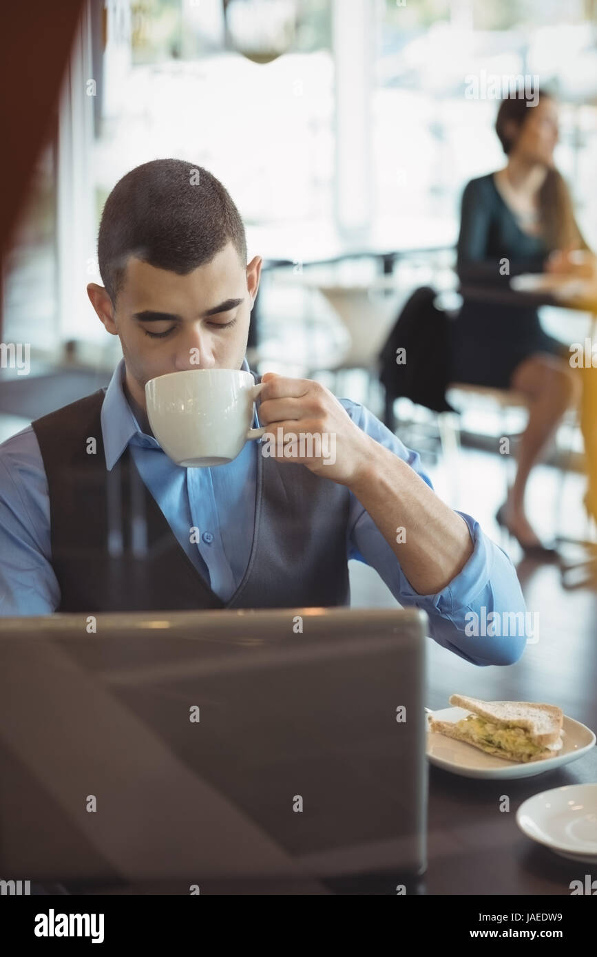 Businessman having coffee in office cafeteria Stock Photo