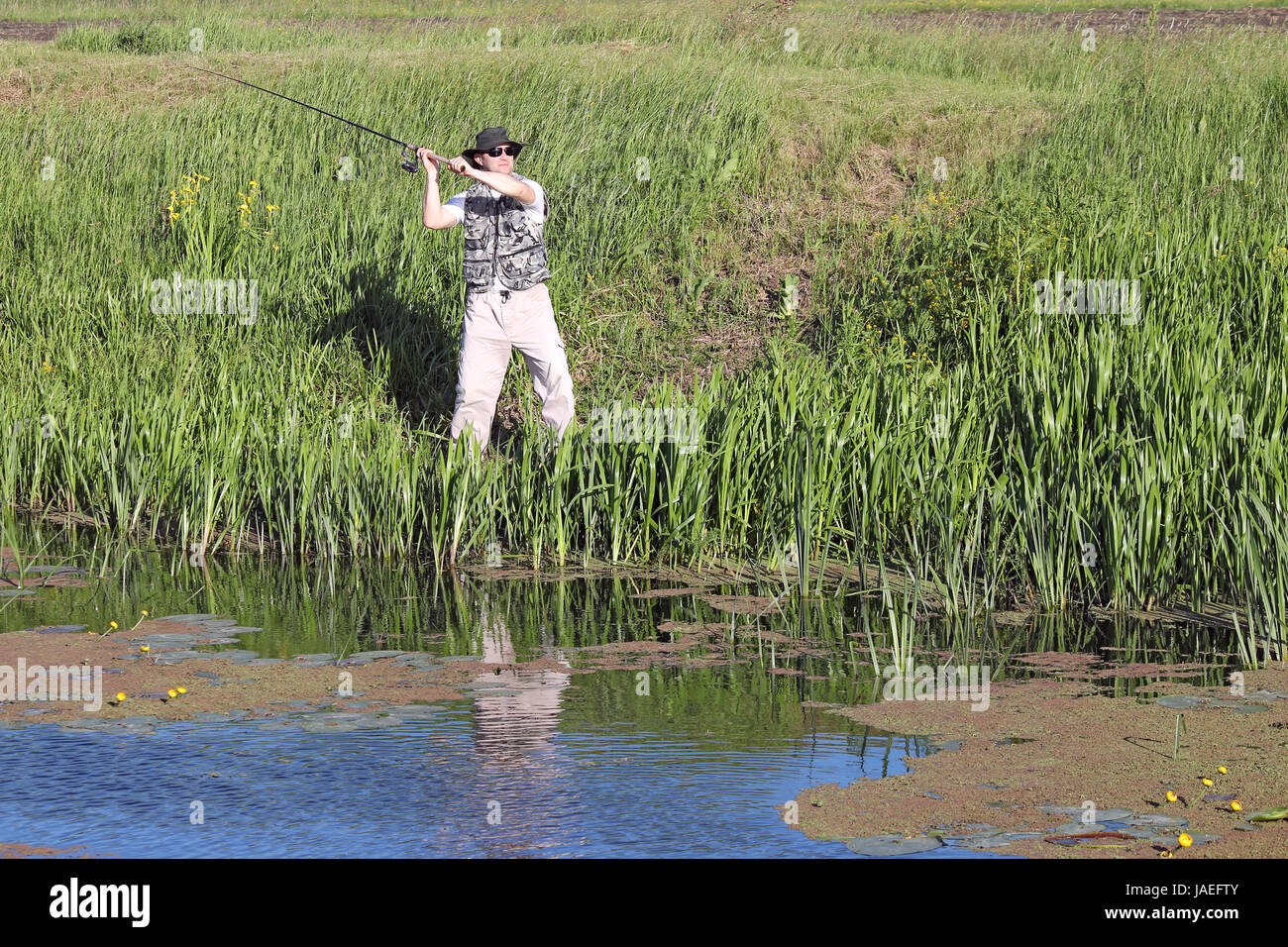 fisherman flying fishing on river Stock Photo - Alamy