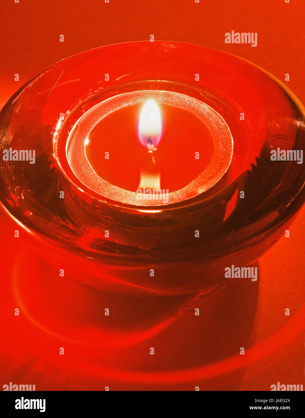 burning red tea candle in a glass bowl Stock Photo Alamy