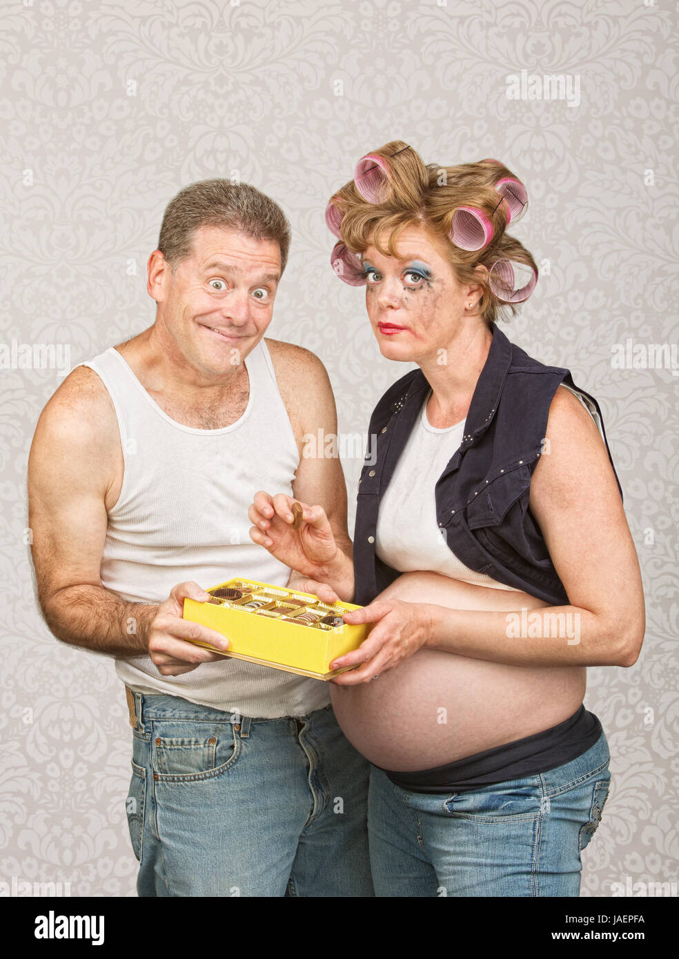 Guilty pregnant woman eating candy with smiling man Stock Photo Alamy
