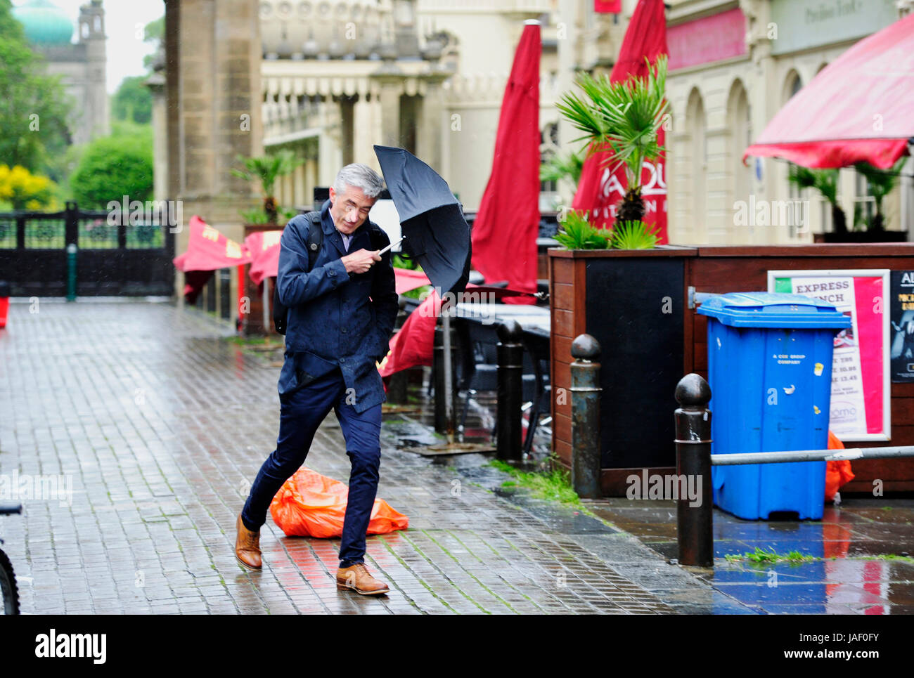 Brighton, UK. 6th June, 2017. It's a struggle walking with an umbrella through Brighton as storms with high winds and driving rain batter the south coast of Britain today with more unsettled weather forecast for the next few days Credit: Simon Dack/Alamy Live News Stock Photo