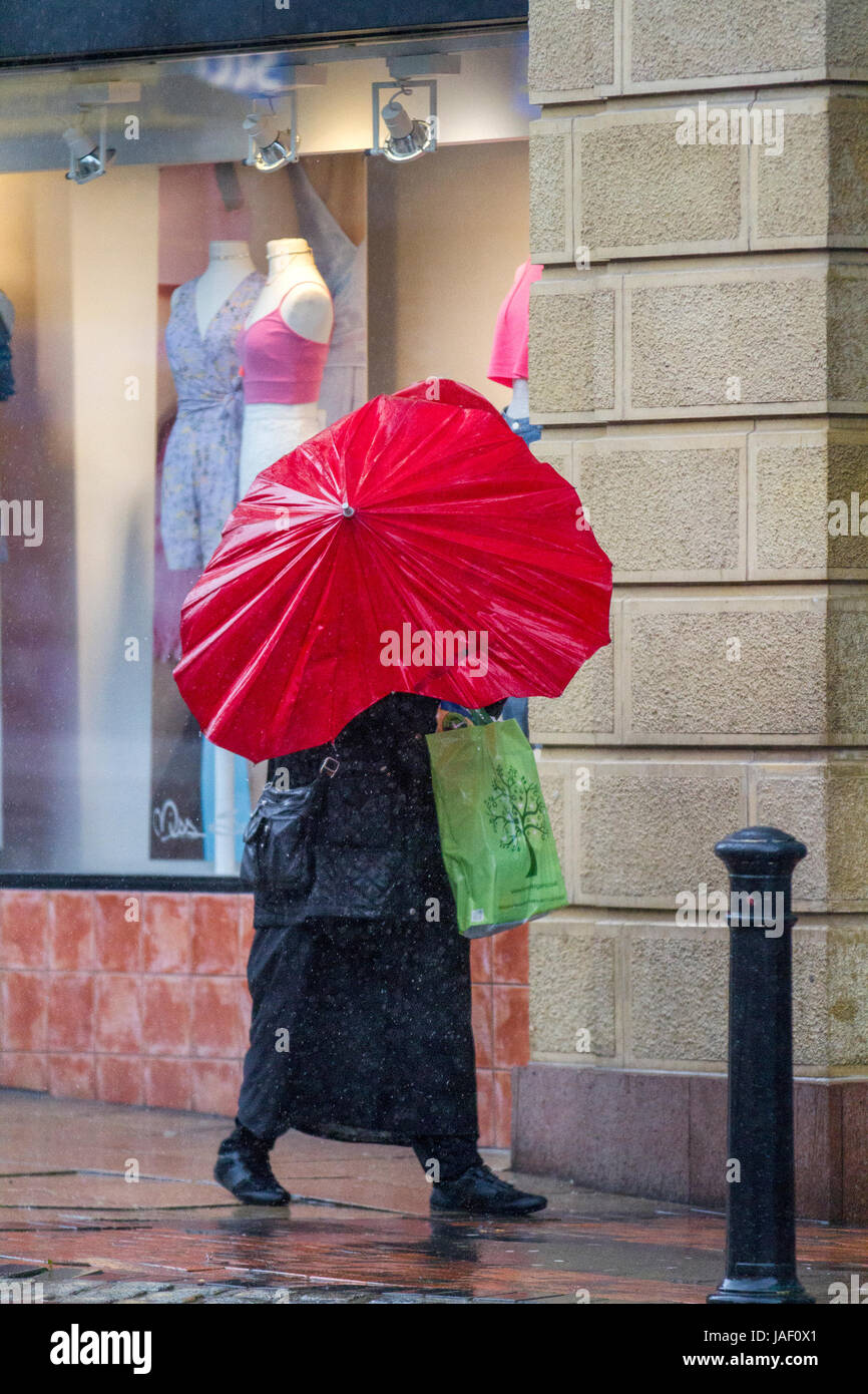 Broken, bent red umbrella on a rainy day in Preston, Lancashire. UK ...