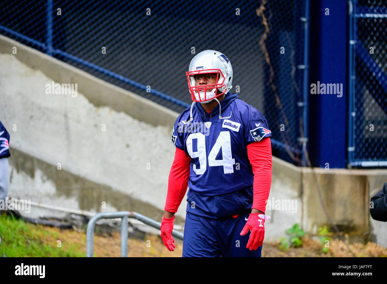 Foxborough, Massachusetts, USA. 6th June, 2017. New England Patriots defensive end Kony Ealy (94) walks to practice in the rain at the New England Patriots mini camp held on the practice field at Gillette Stadium, in Foxborough, Massachusetts. Eric Canha/CSM/Alamy Live News Stock Photo
