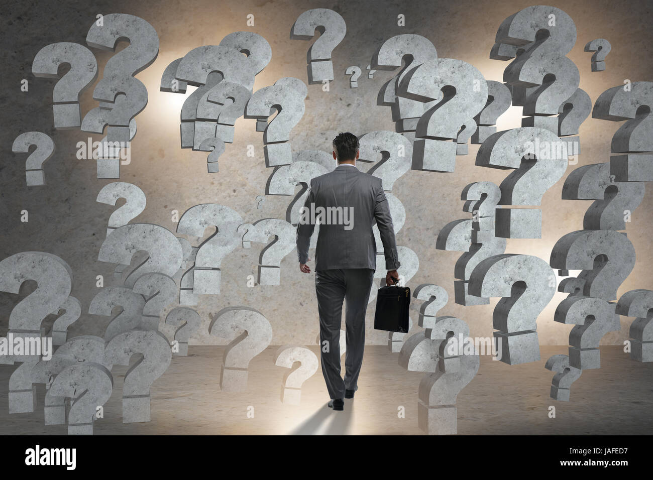 Businessman facing questions in business Stock Photo Alamy