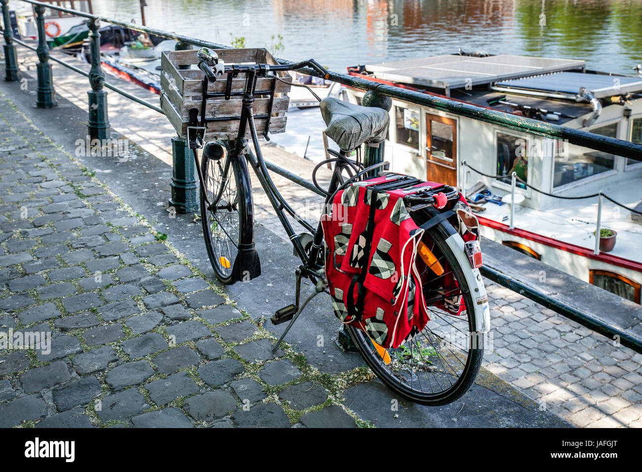 Woman's bike with red bags parked near yacht marina Portus Ganda - Ghent, Flanders, Belgium Stock Photo