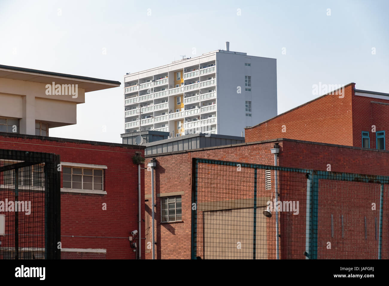 Council housing high rise flats in East London surrounded by red brick industrial looking buildings Stock Photo