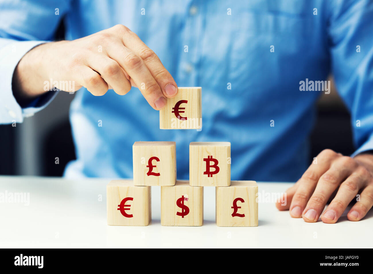 concept of businessman building financial pyramid Stock Photo