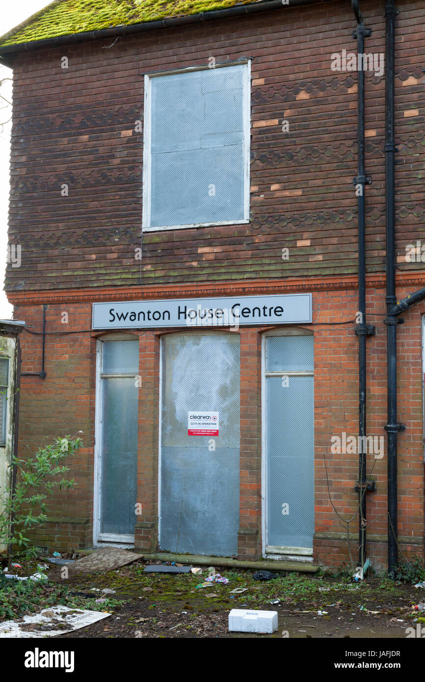 Galvanised steel security panel on the rear of the Swanton House Centre with signage. A now derelict building. Ashford, Kent Stock Photo