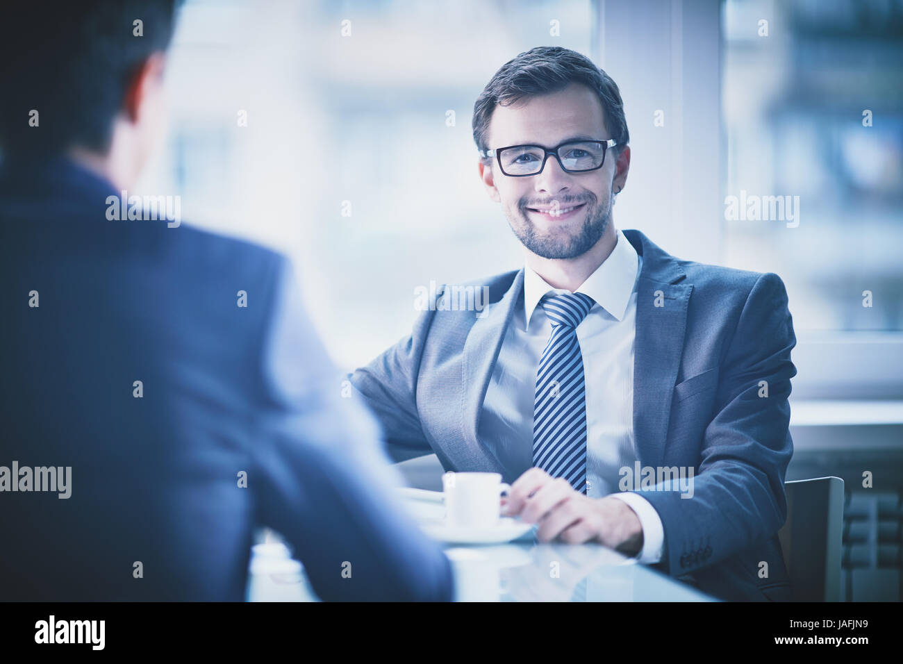 Image of young businessman with cup of coffee looking at camera Stock ...