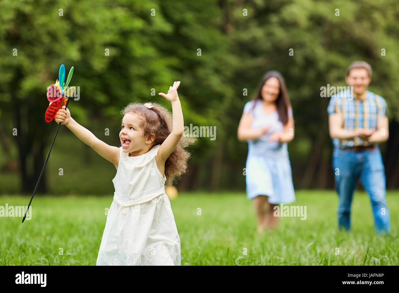 Happy family walking playing in the park Stock Photo - Alamy