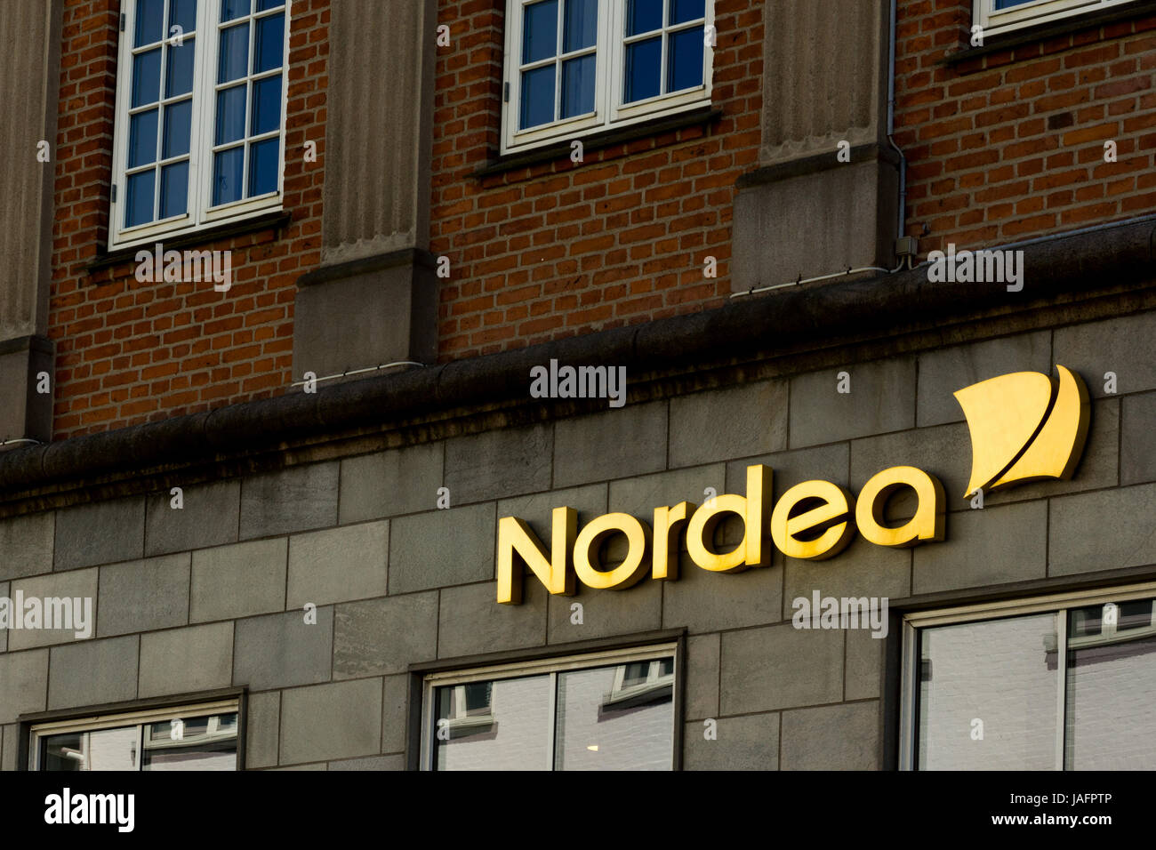 Golden Nordea sign and logo on a wall in Roskilde, Denmark, May 26, 2017 Stock Photo