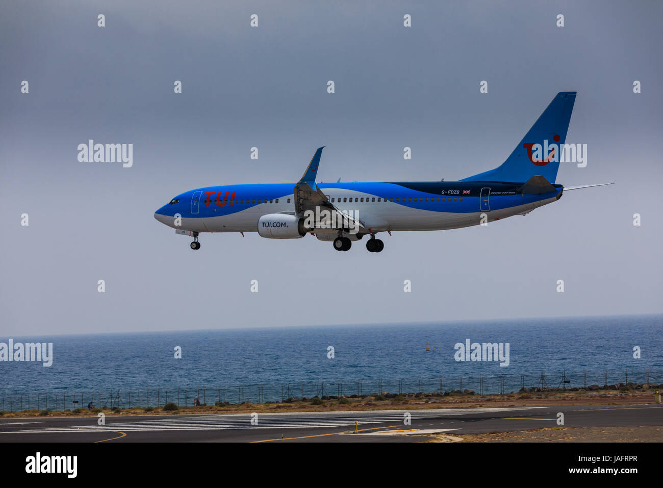 ARECIFE, SPAIN - APRIL, 16 2017: Boeing 737-800 of TUI with the registration G-FDZB landing at Lanzarote Airport Stock Photo