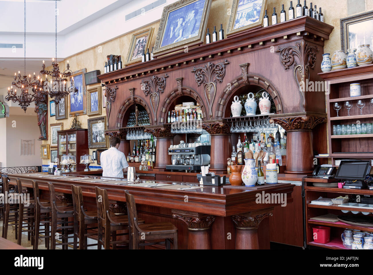 A old fashion stool lined large bar and counter with drinks bottles and
