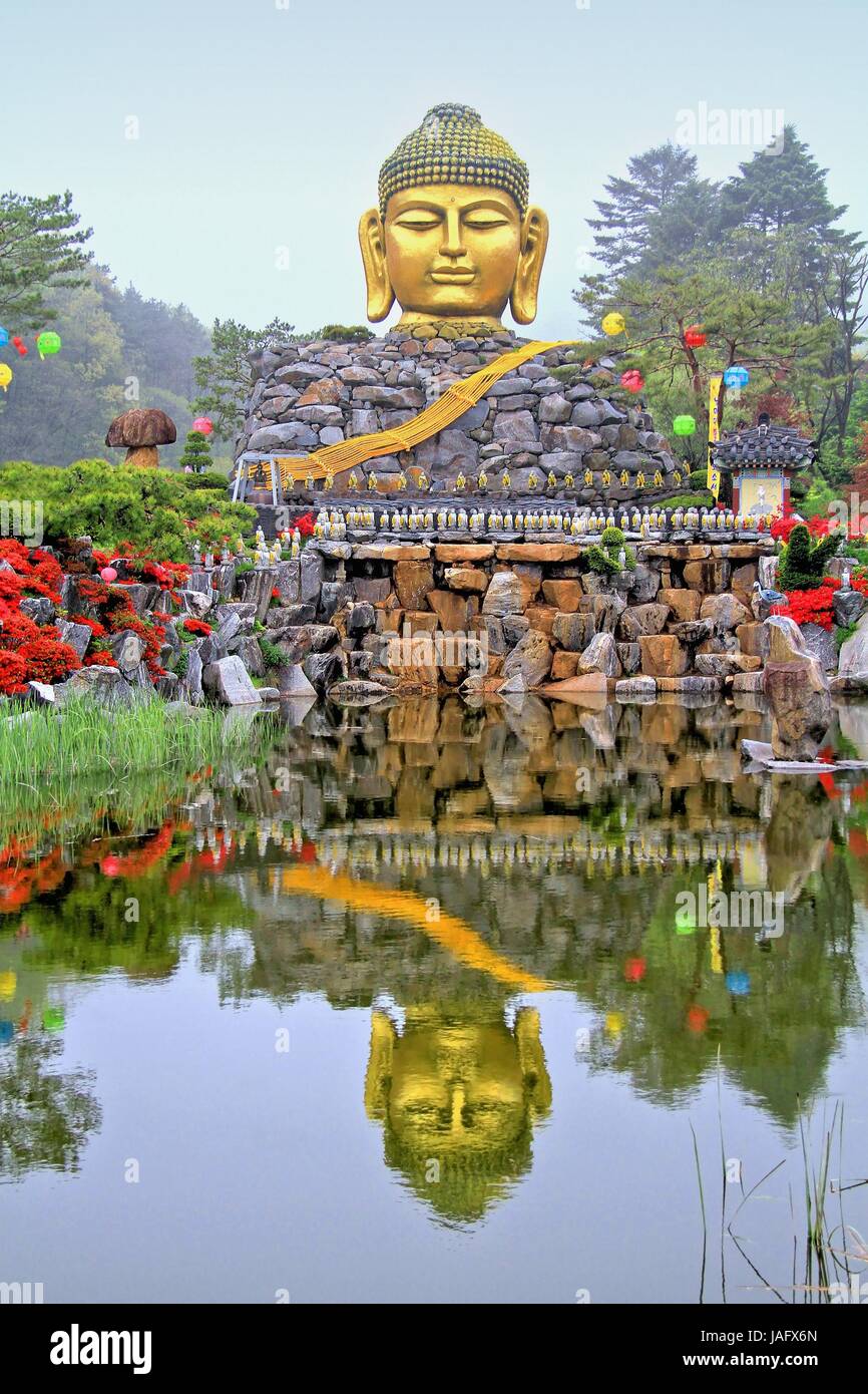 Golden head big Buddha statue with body made from stones, The Yunwha