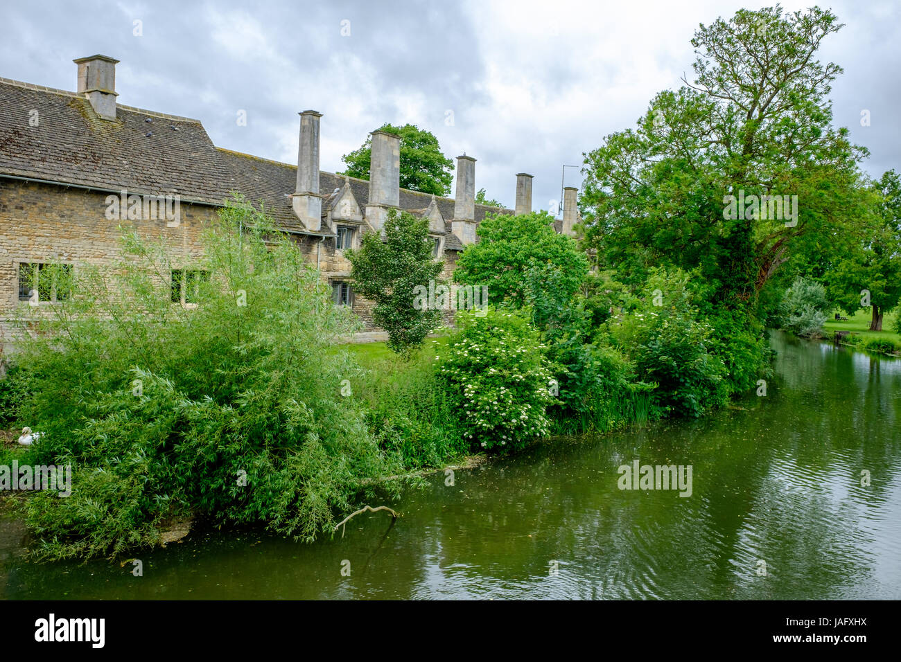 Stone riverside buildings on the bank of the river Welland at Stamford, a mainly stone town in Lincolnshire, England. Stock Photo