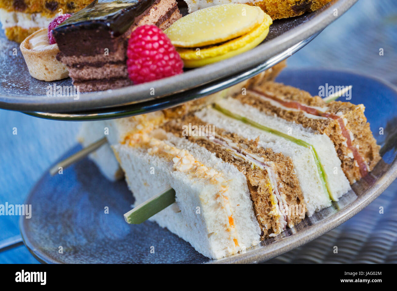 Close up of a selection of sandwiches and cakes, traditional afternoon tea. Stock Photo