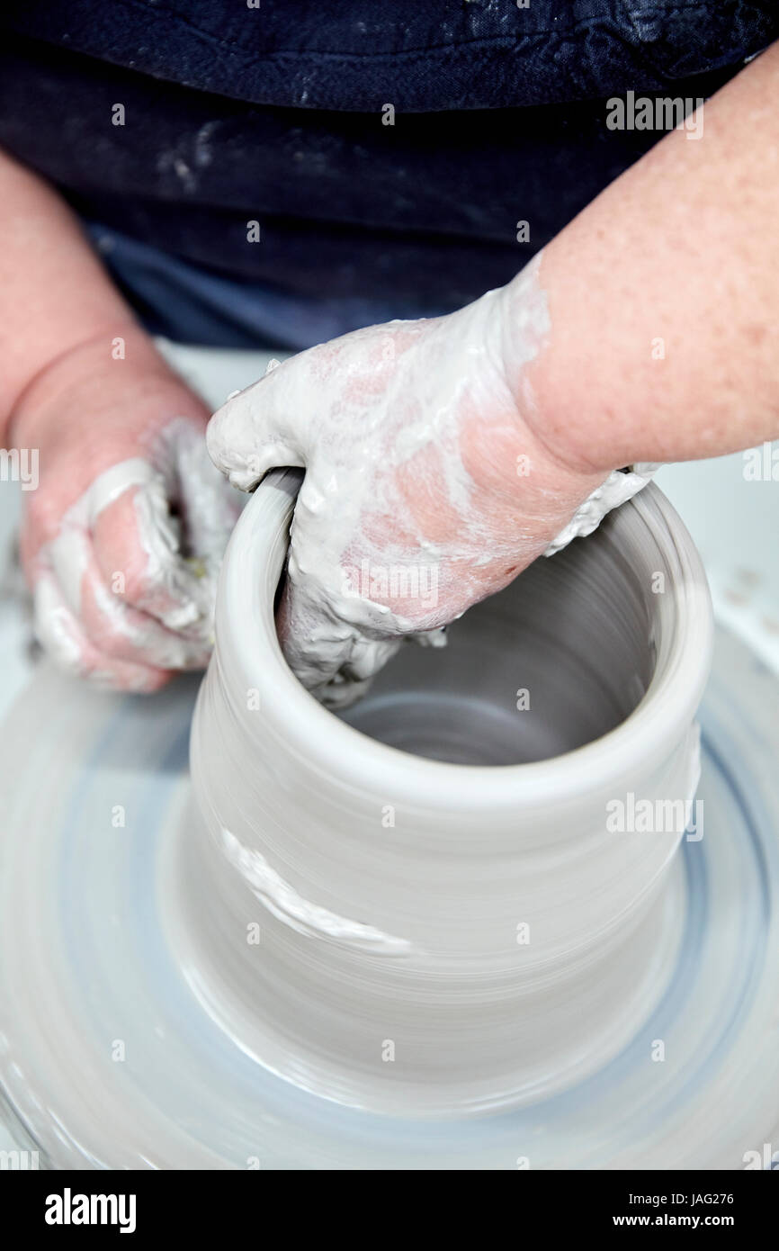 A person hrowing a clay pot on a potters wheel, seen from above Stock Photo