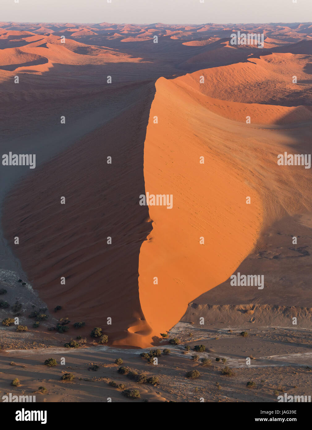 View from a helicopter of one of the large red sand dunes of Sossusvlei in Namibia Stock Photo