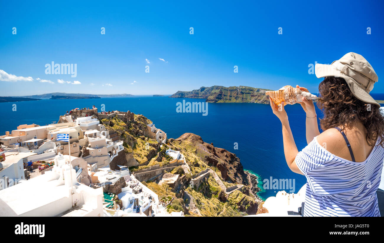 Oia town on Santorini island, Greece. Traditional and famous houses and churches with blue domes over the Caldera, Aegean sea Stock Photo