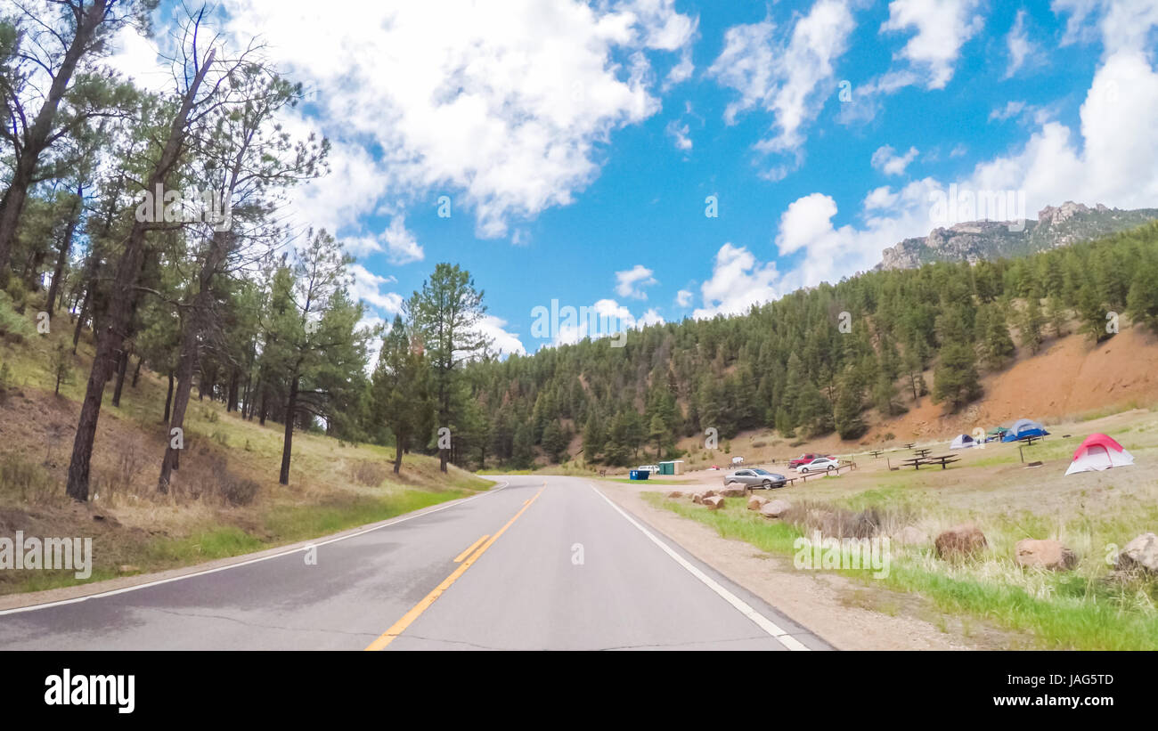 Driving on small road near the mountain creek in rural area of Western Colorado. Stock Photo