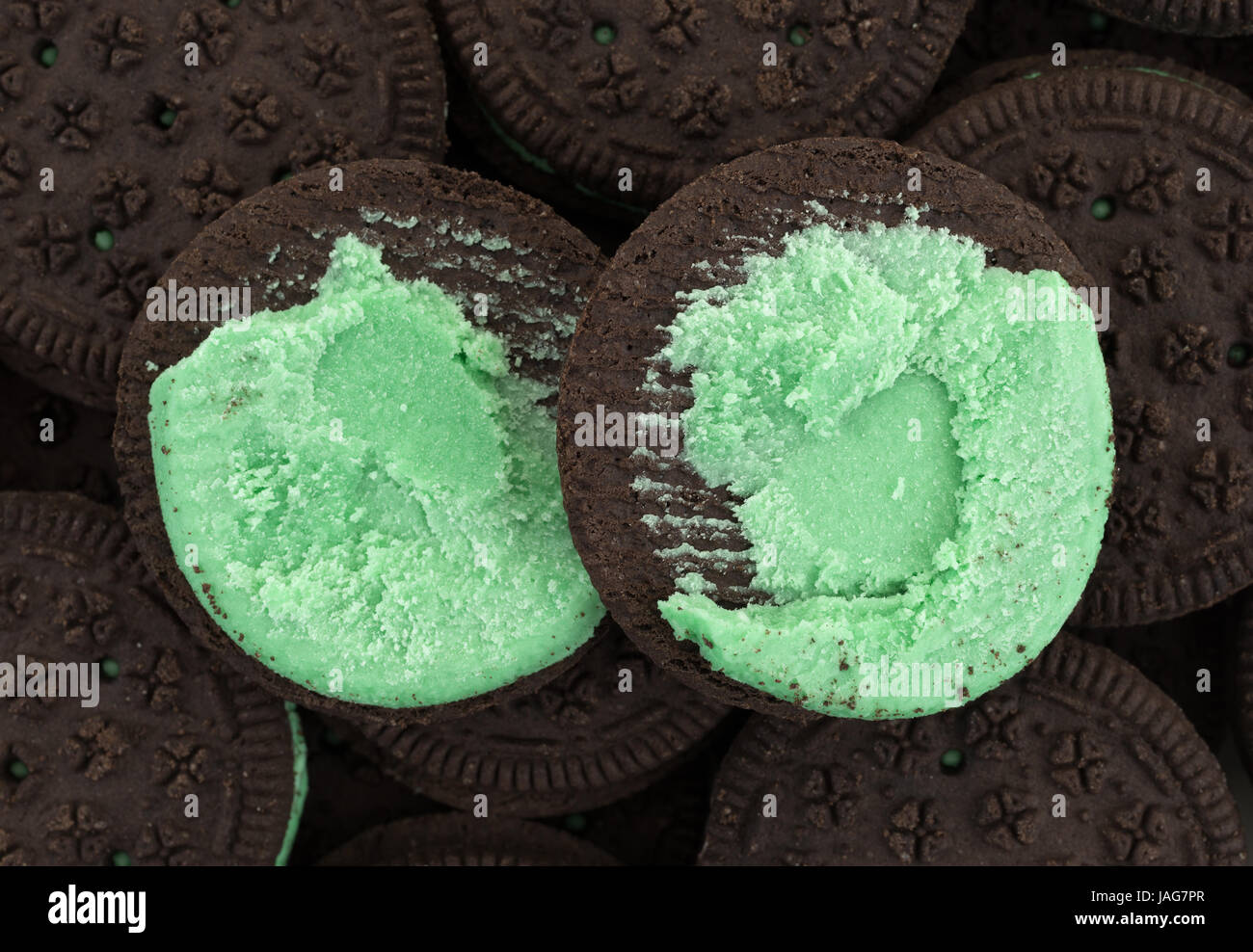 Top close view of an opened mint creme sandwich cookie atop other cookies. Stock Photo