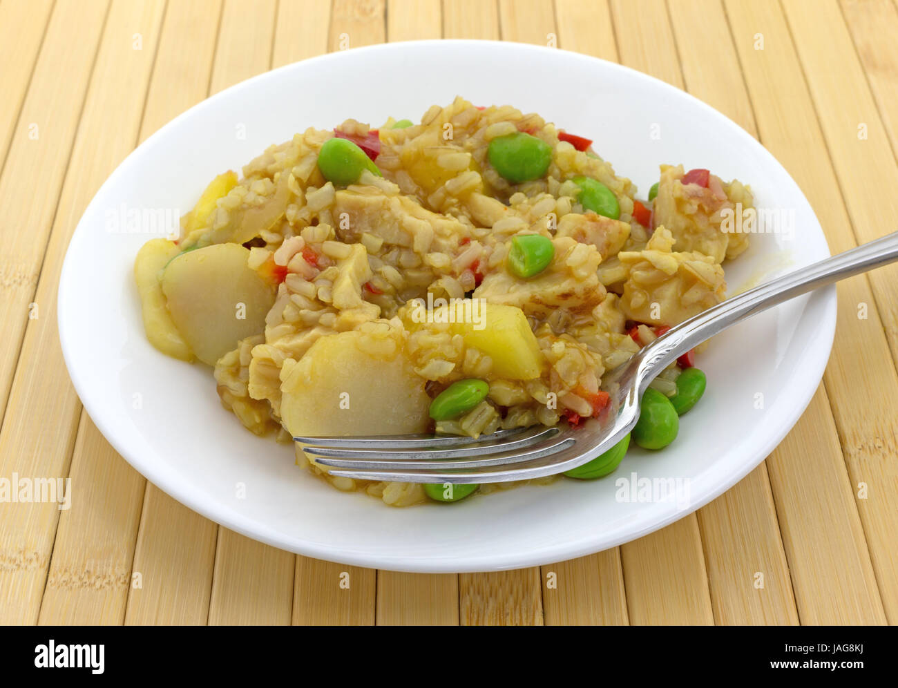 A meal of chicken, rice, water chestnuts, red peppers and pineapple
