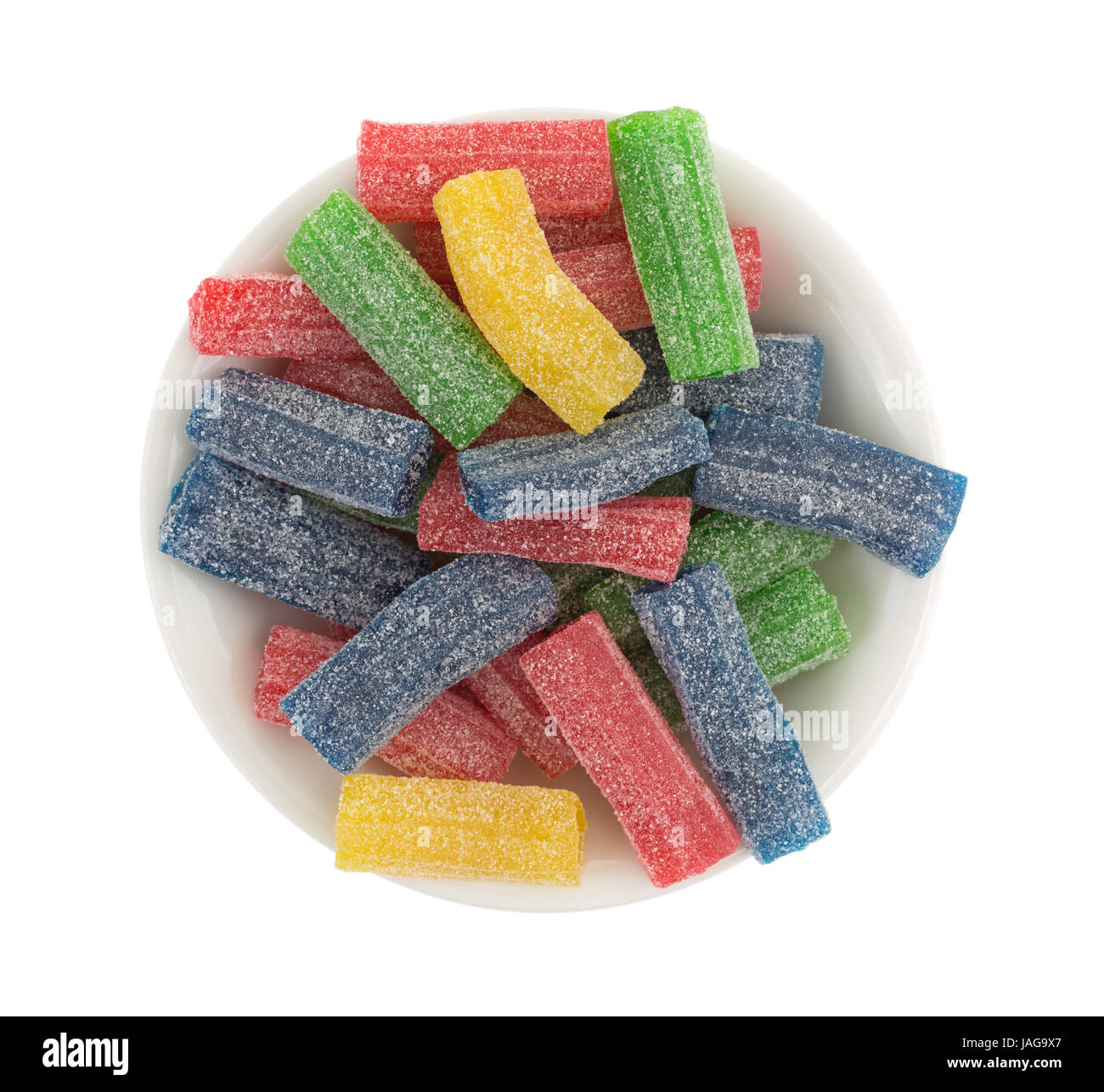 Top view of gummy sweet and sour sugar candy in a bowl isolated on a