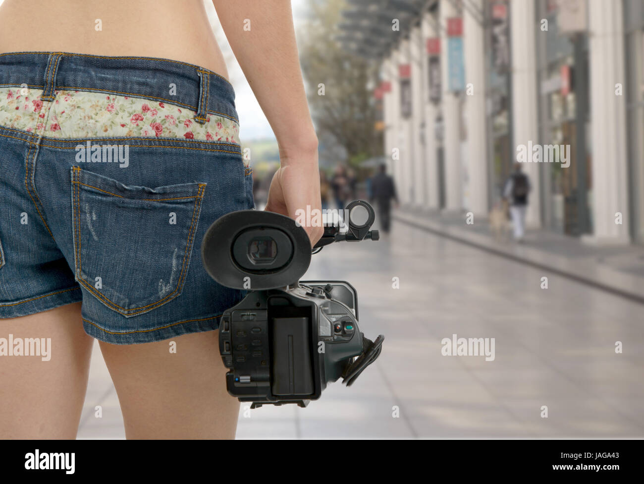 a cameraman girl holding his professional camcorder in the street Stock ...