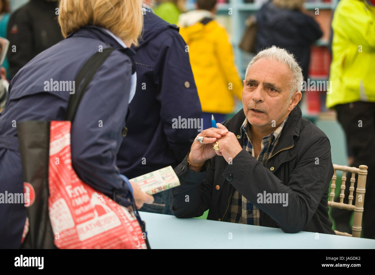 Hanif Kureishi screenwriter filmmaker & novelist pictured book signing for fans in the bookshop at Hay Festival 2017 Hay-on-Wye Powys Wales UK Stock Photo