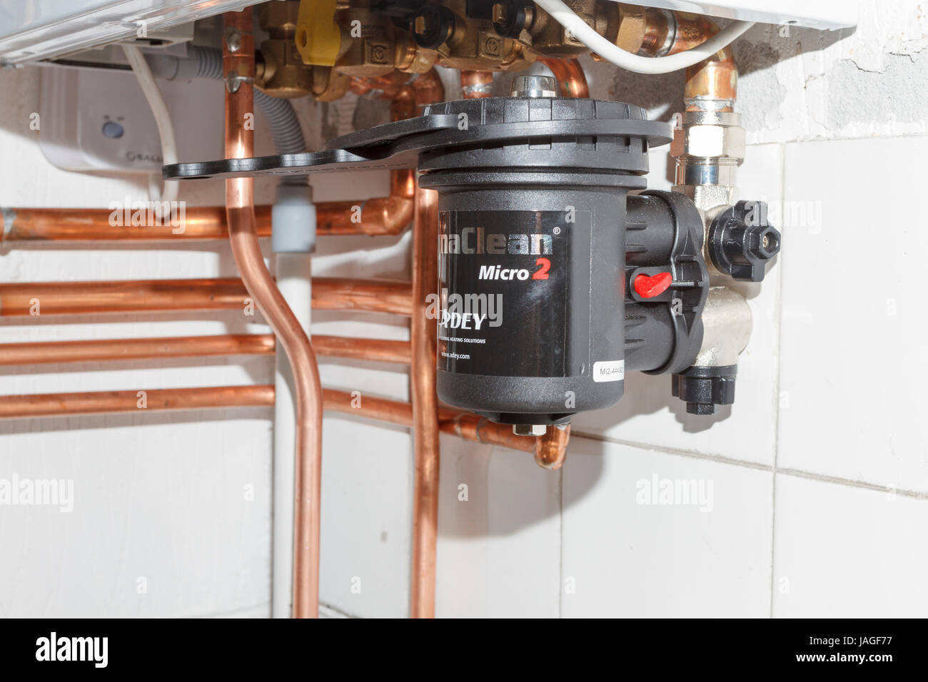 Magnaclean magnetic water filter installed on domestic gas combi boiler, UK Stock Photo