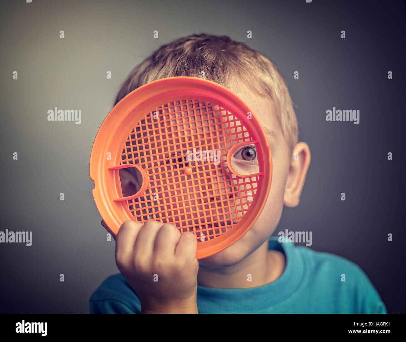 Preventing Child Abuse concept portrait of kid hide himself with toy Stock Photo