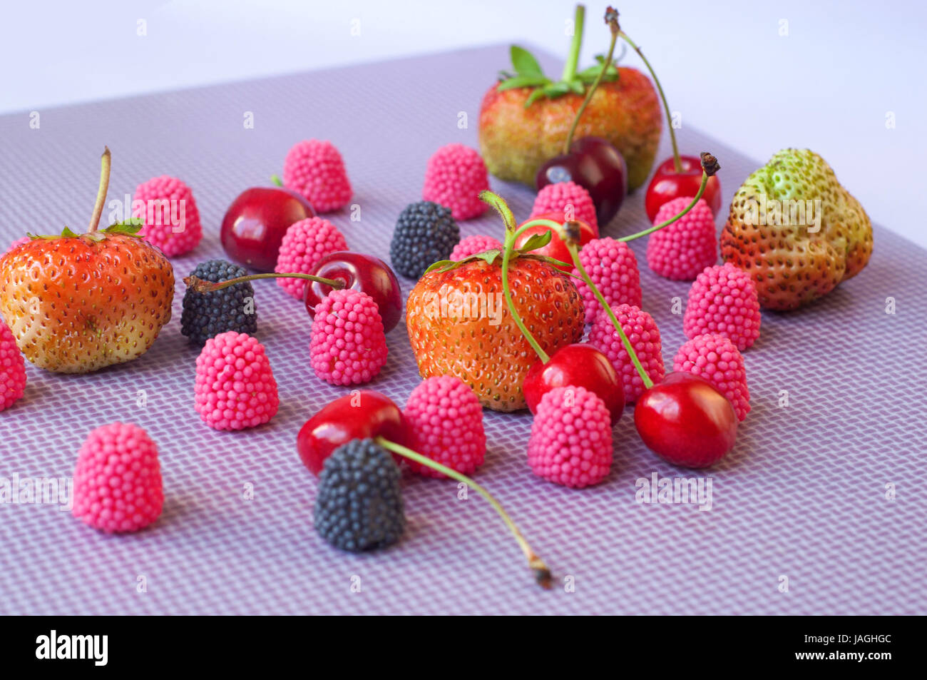 A group of strawberries, cherries and candies raspberry isolated on the ...