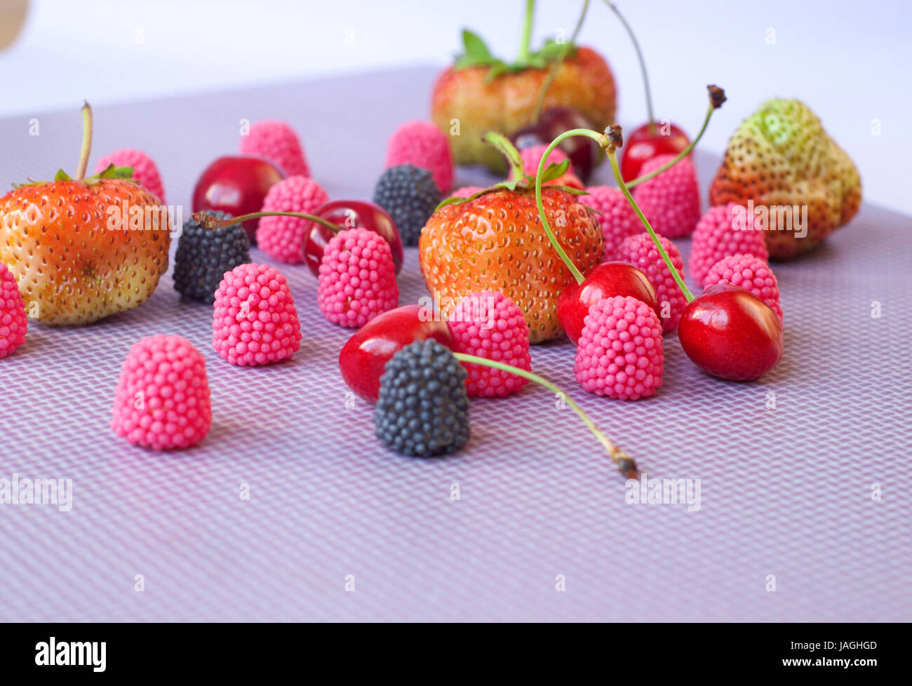 A group of strawberries, cherries and candies raspberry isolated on the ...
