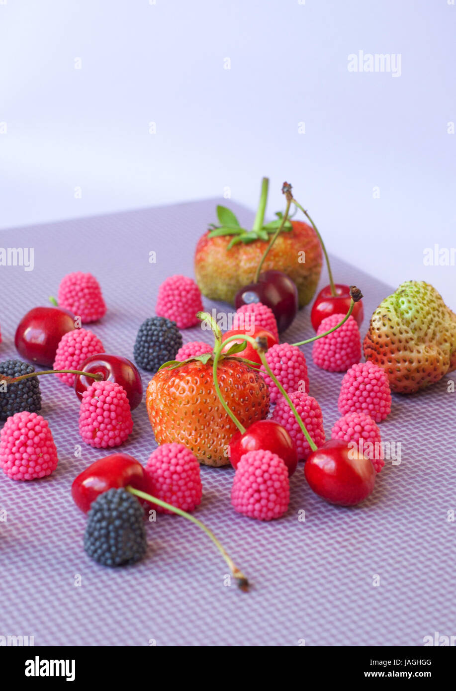 A group of strawberries, cherries and candies raspberry isolated on the ...