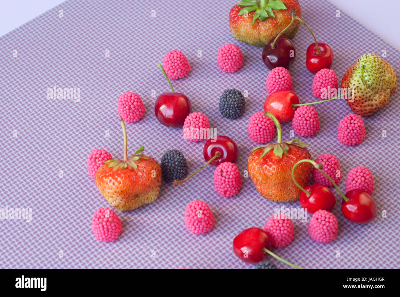 A group of strawberries, cherries and candies raspberry isolated on the ...